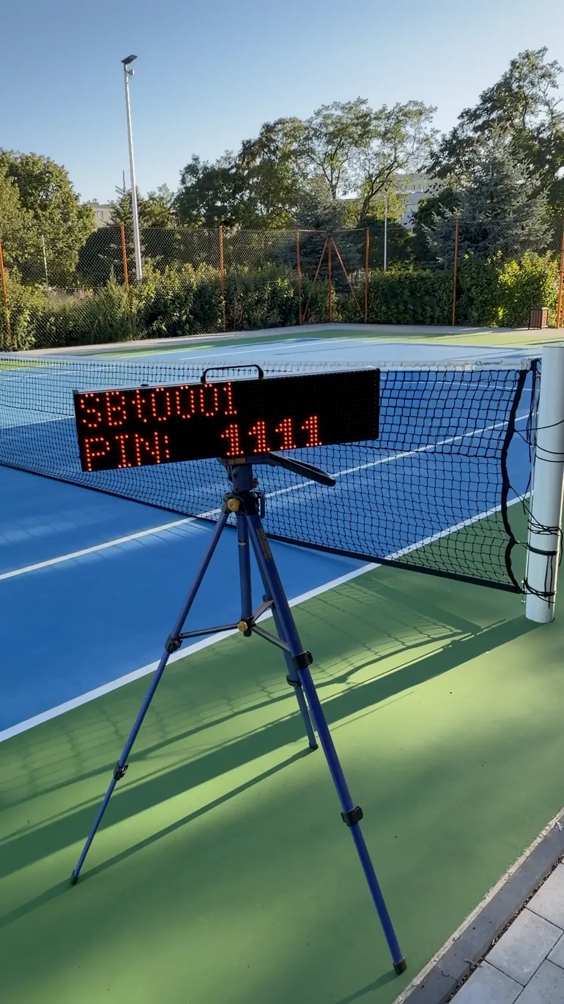 ScreenBattle scoreboard on court displaying its local Wi-Fi network name and the PIN needed to connect a phone